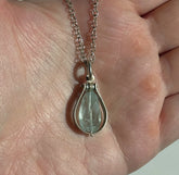 Fig Drop Pendant Necklace by Ayala Naphtali displayed in hand, featuring a tear-shaped gemstone