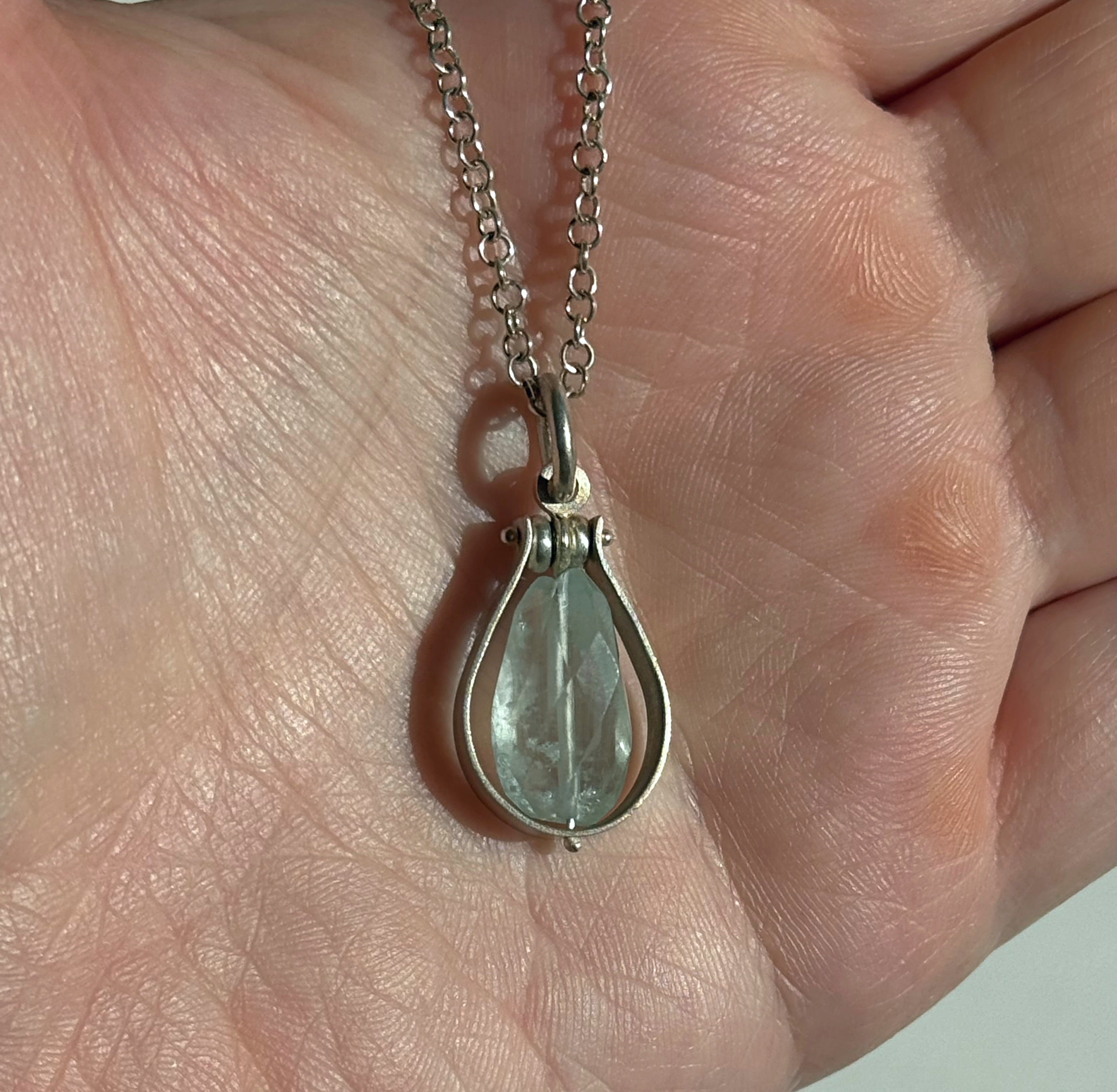 Fig Drop Pendant Necklace by Ayala Naphtali displayed in hand, featuring a tear-shaped gemstone