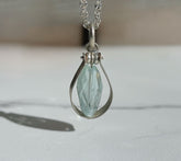 Fig Drop Pendant Necklace from The W Gallery featuring a sparkling blue pendant on a silver chain