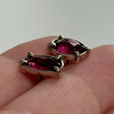 Elegant Rhodolite garnet earrings set in a silver design, showcasing their rich red color
