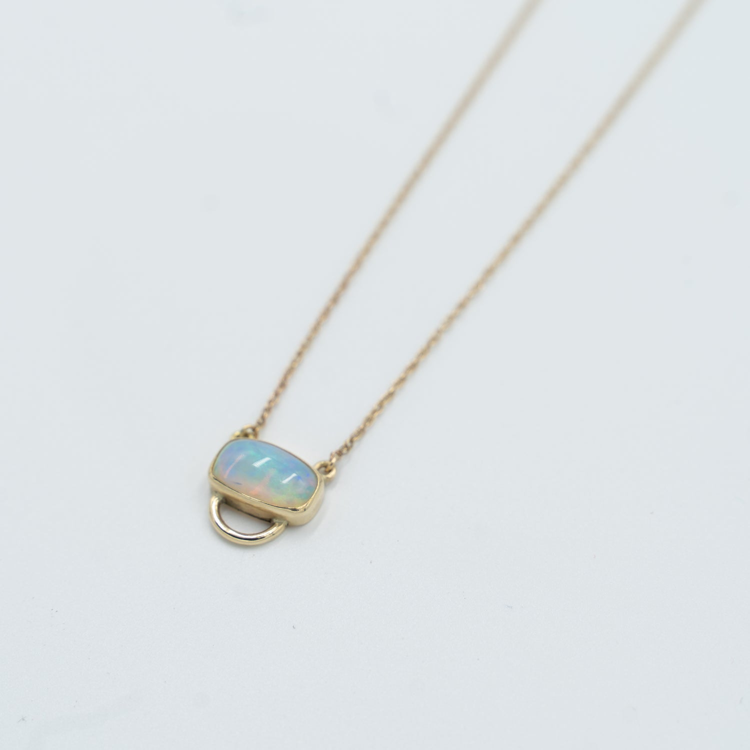 Unique opal pendant necklace featuring a stunning opal stone set in gold from Tess Young Jewelry