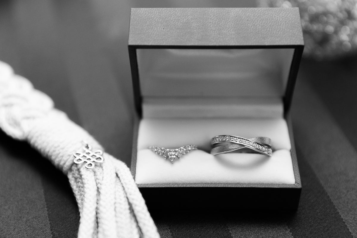 A handmade wedding band set with custom engraving in jewelry box