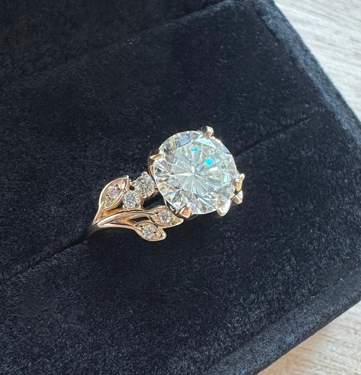 A large diamond custom wedding ring in black jewelry box