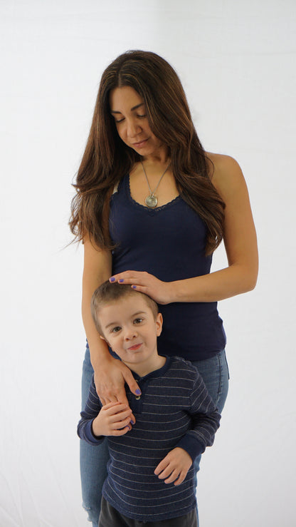 Model with child wearing a nesting disc necklace with the names of her children