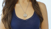 Model wearing a nesting disc necklace with the names of her children