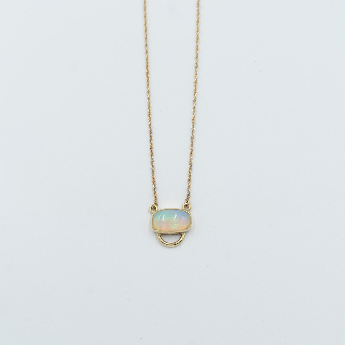 Unique opal pendant necklace with a delicate gold chain and oval opal stone from Tess Young Jewelry at The W Gallery