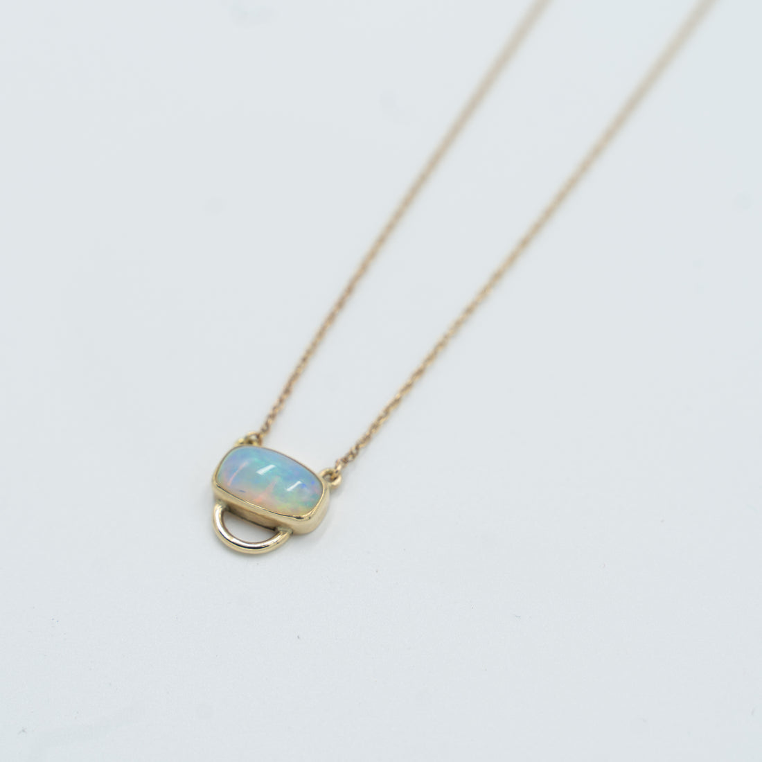 Unique opal pendant necklace featuring a stunning opal stone set in gold from Tess Young Jewelry